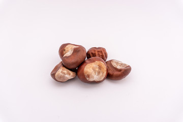 A pile of chestnuts on a white background