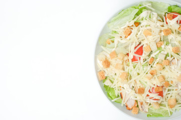 light summer salad in a white plate on a white background