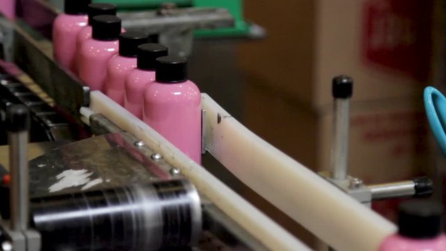 Acrylic Paint Bottle Machine Filling Pink Paint in Factory
