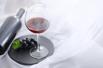 Glass with grape red semi-dry wine. Valentine's day concept background. Gift for the holiday. Sweet sparkling wine.