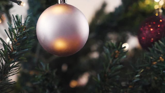 Beautiful Silver Christmas Bulb In The Christmas Tree With Light Reflections And Tree Branches.