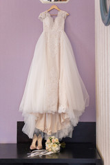 Fototapeta na wymiar wedding dress hanging on a hanger in the room