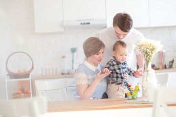 Obraz na płótnie Canvas family plays in the kitchen with a child