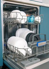 Dishware (plates) inside built-in dishwasher. Dishwashing machine rack