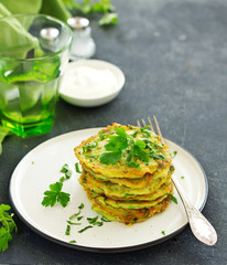 Fritters from zucchini and greens with poached egg. Healthy breakfast. Selective focus