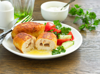 Chicken Kiev with vegetable salad. Ukrainian food.