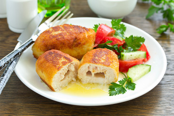 Chicken Kiev with vegetable salad. Ukrainian food.