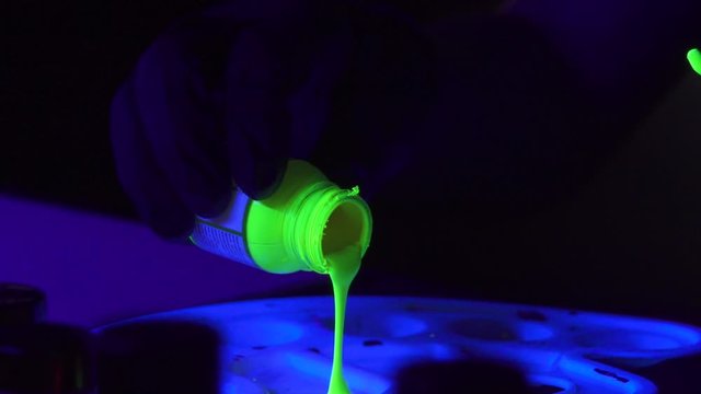 Pouring Neon Glow in the Dark Acrylic Paint from bottle to Painter's Palette in Slow Motion