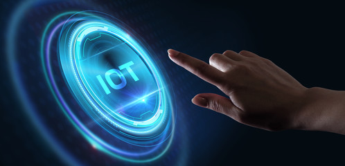 Internet of things - IOT concept. Businessman offer IOT products and solutions. Young businessman  select the abstract chip with text IoT on the virtual display.