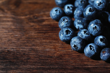 Water drops on ripe sweet blueberry. Fresh blueberries background with copy space for your text. Vegan and vegetarian concept. Macro texture of blueberry berries.