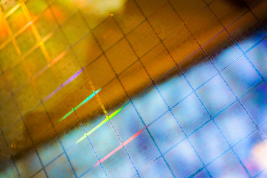 Close up of a silicon wafer of SIM computer chips.