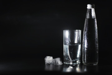 Close up pouring purified fresh drink water from the bottle on table in living room. Drinking water. Mineral vitamin water. Healthy, mineral-rich, refreshing water.