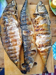 baked fish on a wooden board