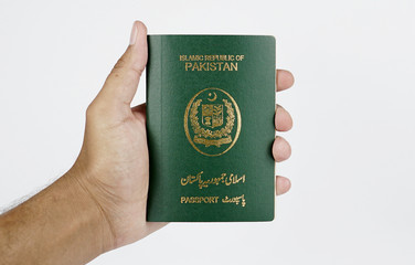 Brown man holding Pakistani Passport