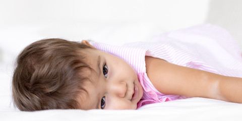 portraits of a baby in bed