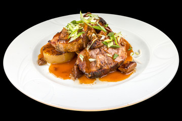Tasty Porchetta with mushrooms, and spices on a plate, isolated on black background.