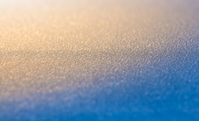 dew drop on blue ground with orange day light
