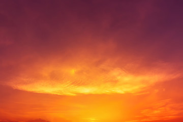 Dark red sky with orange and yellow light with blurred clouds