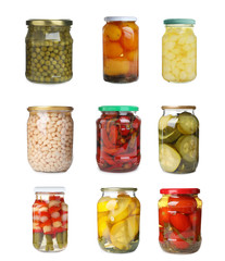 Set of jars with pickled vegetables on white background
