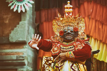 Dancer man in traditional Balinese costume and Topeng Wayang mask