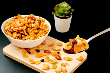 Homemade Honey caramel cornflakes in black background Healthy food concept