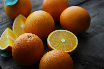 Orange citrus fruit on a stone table. Orange background.