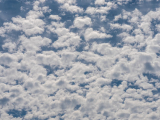 Blue sky background with white clouds.