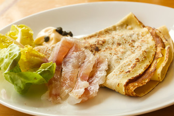 Gravlax with pancake served salad