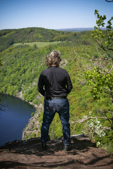 Man looking on view of Vltava river horseshoe shape meander from Maj viewpoint in Czech republic