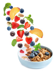 Delicious yogurt with oatmeal, nuts, fruits and berries on white background