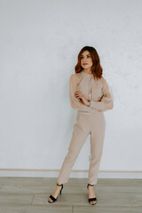 Beautiful sexy young business woman brunette hair evening makeup wearing dress suit top white jeans skirt high heels shoes business clothes for meetings walks summer fall collection perfect body shape