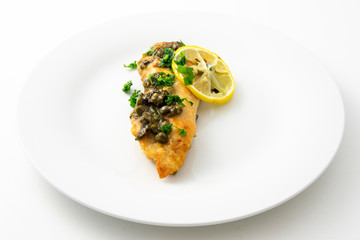 Chicken piccata with sauce, lemon and capers