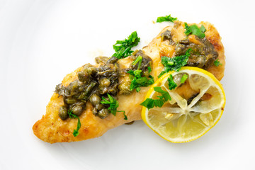 Chicken piccata with sauce, lemon and capers