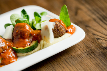 Meatballs with tomato sauce and cucumbers