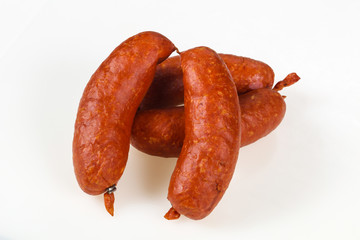 Tasty meat sausages over white background