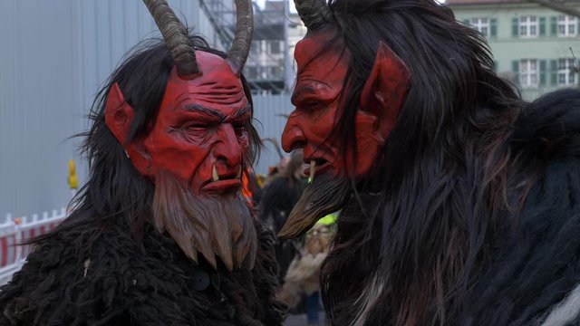 Wooden masks at the Krampuslauf in Munich, Bavaria, Germany