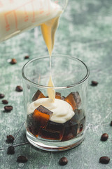 Coffee Jelly- a famous dessert made out of coffee flavored jelly, cream and condensed milk-pouring cream