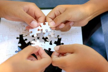 Pieces of jigsaw on palm,Pieces of jigsaw puzzle in hands.