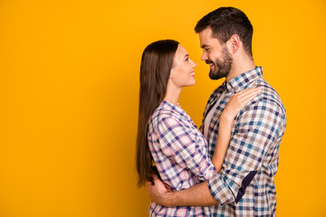 Profile photo charming lady handsome guy toothy smiling tenderness look eyes love emotions hugging stand close going to kiss wear casual plaid shirts isolated yellow color background
