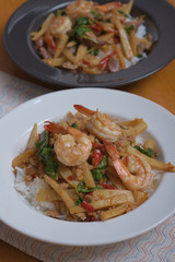 Rice topped with stir-fried pork shrimp bamboo shoot and basil