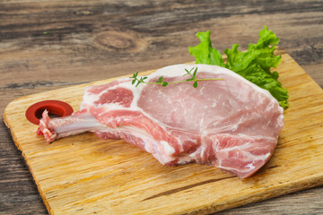 Raw pork bone steak over wooden