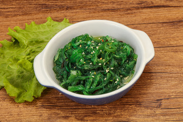 Green Chuka Seaweed Salad Isolated on White Background Top View. Wakame Sea Kelp Salat