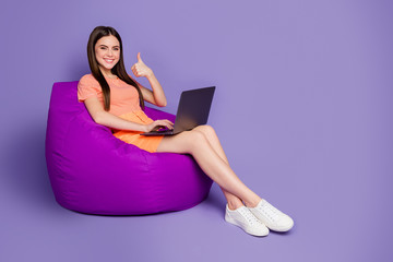 Full body profile photo of nice lady sitting comfy beanbag browsing notebook raise thumb finger up...