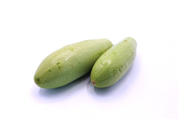 Photo of young zucchini on a white background, close-up