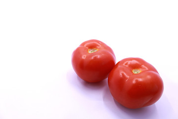 Photo of red tomatoes on a white background, close-up