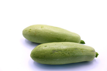 Photo of young zucchini on a white background, close-up