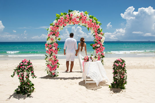 bride and groom at the beach, exotic weddng ceremony 