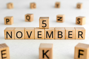 November 5 - from wooden blocks with letters, important date concept, white background random...