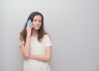 Girl talking on the phone with realatives during quarantine, covid-19, corona virus.
