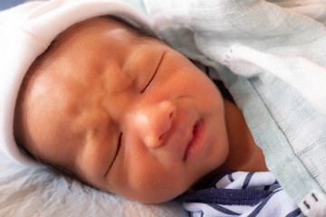 interrupted Crying face of newborn baby infant while sleeping